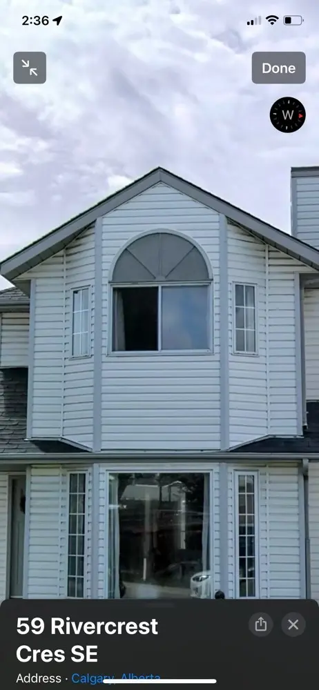 Professional vinyl siding installation by Peakline Roofing & Exteriors at Rivercrest Crescent SE Calgary improving home exterior aesthetics