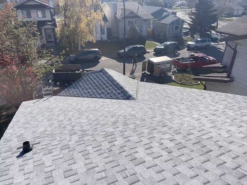 Professional asphalt shingle roof installation by Peakline Roofing & Exteriors showcasing proper flashing and ventilation in Calgary