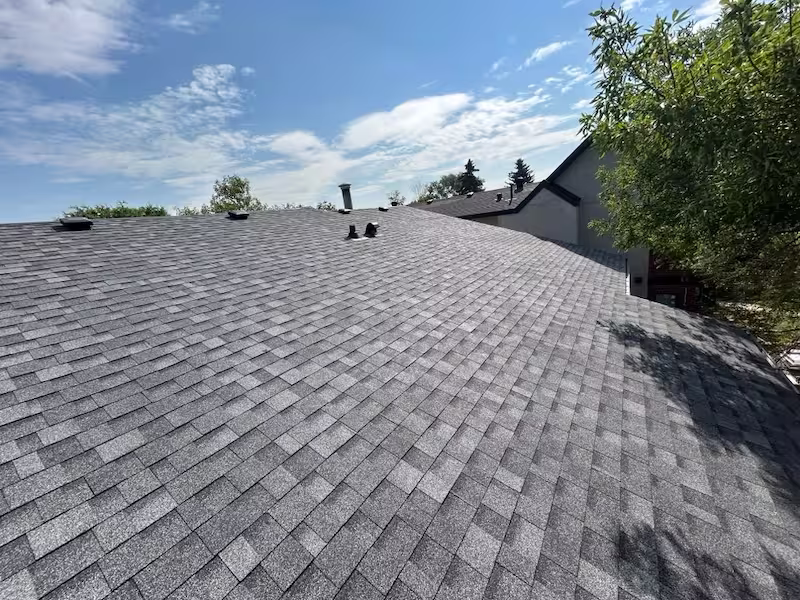 Professional asphalt roof installation by Peakline Roofing & Exteriors with architectural shingles and lifetime warranty in Calgary