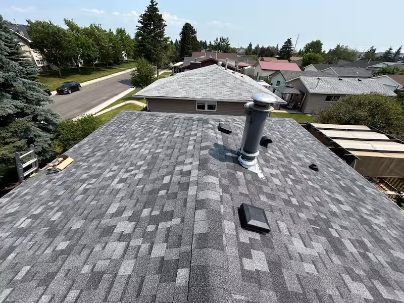 Quality asphalt roof installation by Peakline Roofing & Exteriors with enhanced attic ventilation system for Calgary home efficiency