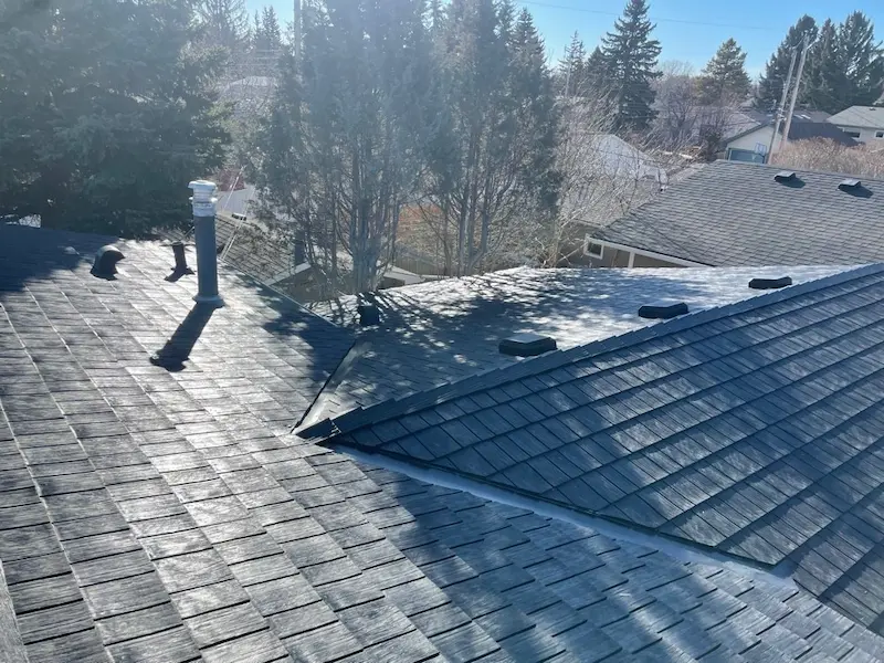 Professional residential roofing installation by Peakline Roofing & Exteriors team with safety equipment and quality materials in Calgary