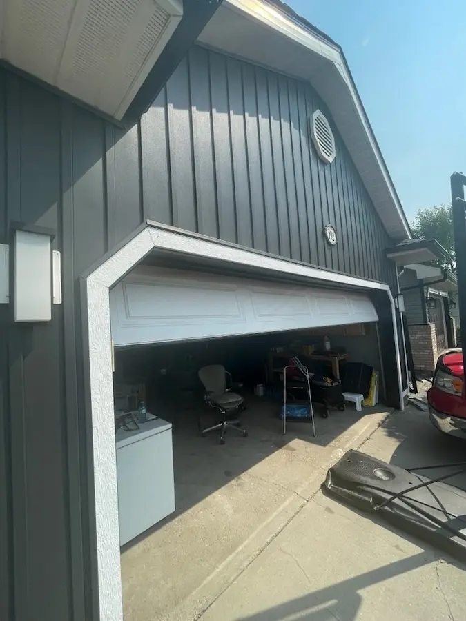 Premium fiber cement board and batten siding installation on garage in Calgary by Peakline Roofing & Exteriors