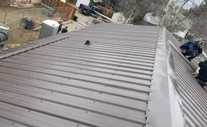Standing seam metal roof installation on modern Calgary home
