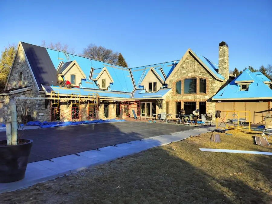 Metal roofing installation in progress by Peakline Roofing & Exteriors showcasing expert craftsmanship and professional worksite in Calgary