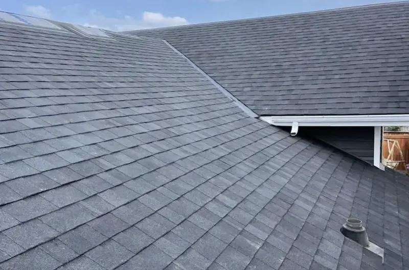 Professional roof repair service in Okotoks, Alberta - Peakline Roofing & Exteriors experts working on residential property