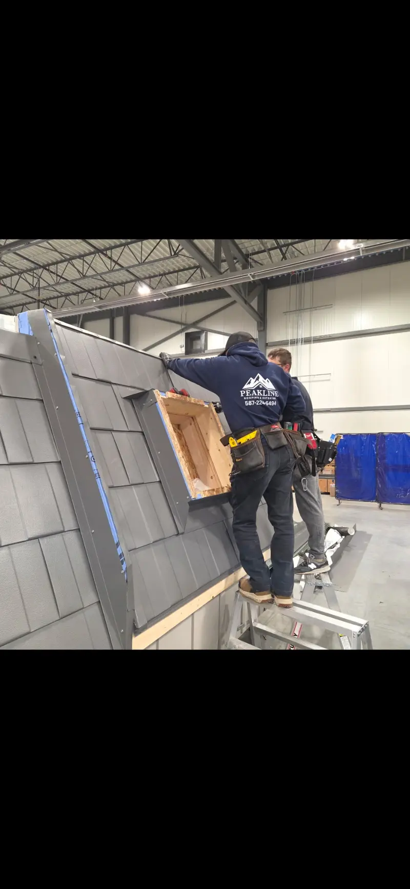 Peakline Roofing crew member practicing metal shingle and skylight installation at training facility