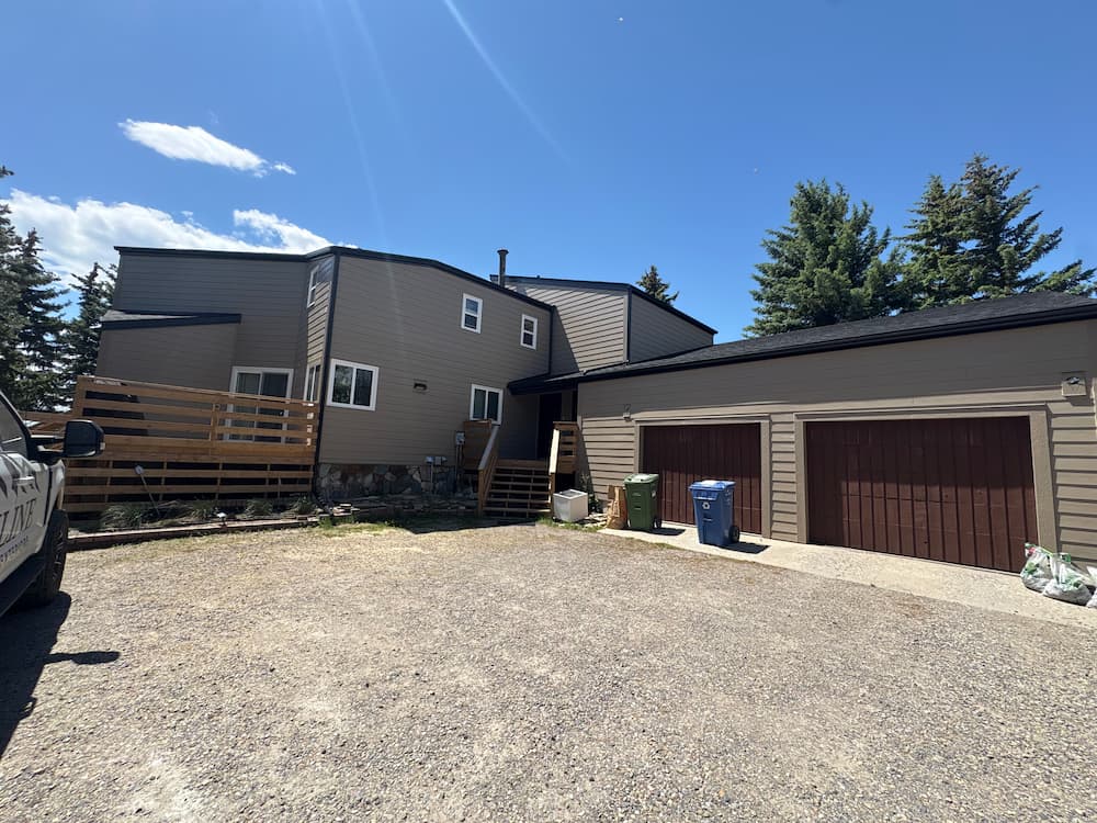 Full exterior James Hardie siding transformation across home and garage in Calgary by Peakline Roofing