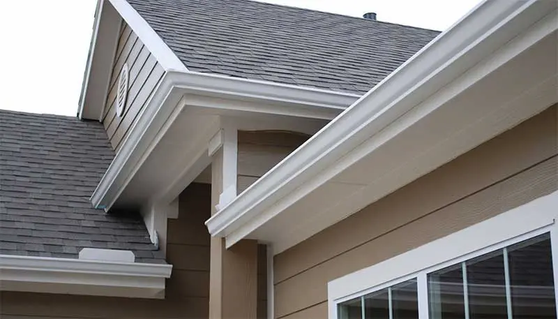 White seamless eavestrough along the roofline of a Calgary home by Peakline Roofing & Exteriors